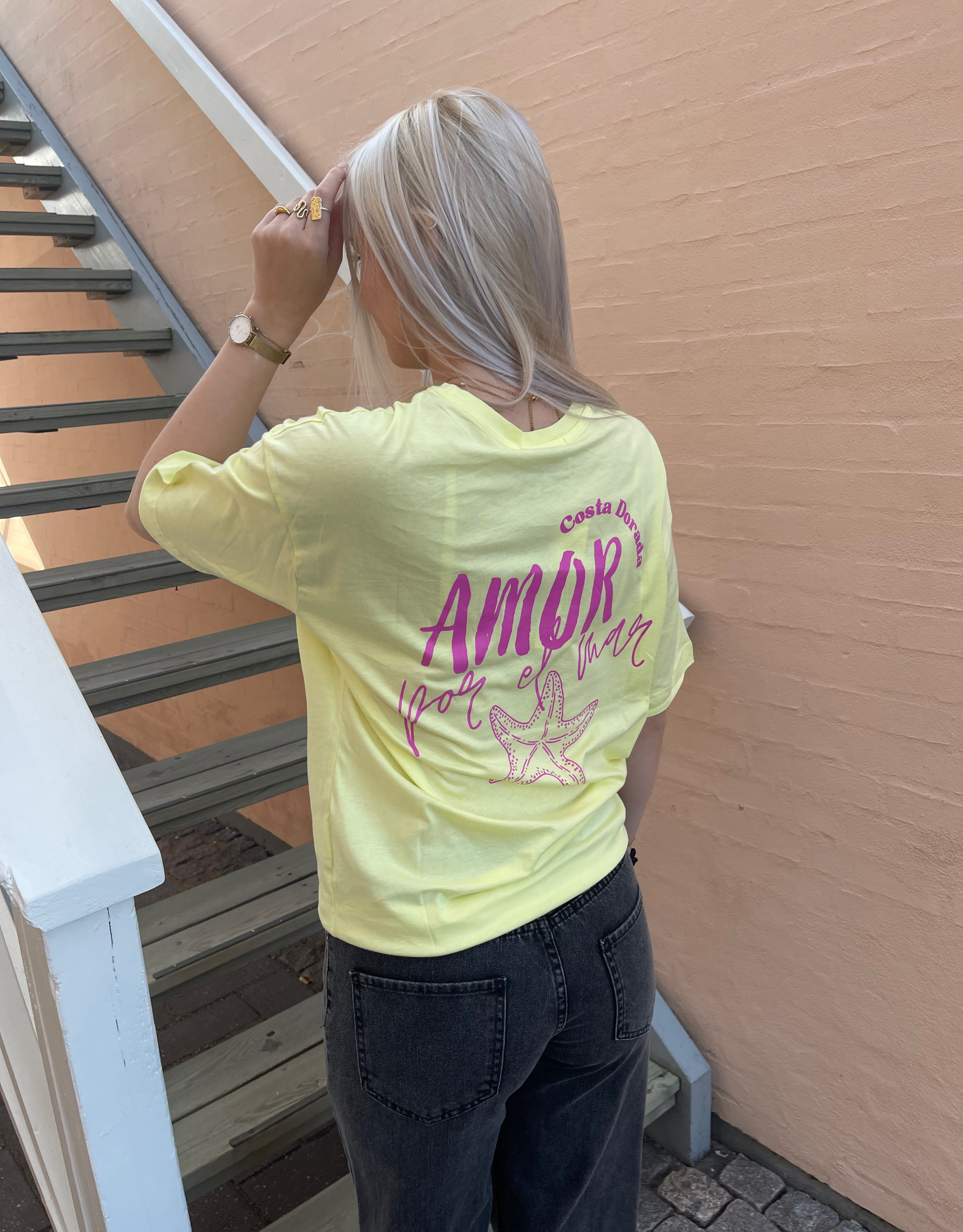 Skøn oversized t-shirt i gul med Amor skrift foran og bagpå samt med en masse detaljer. 