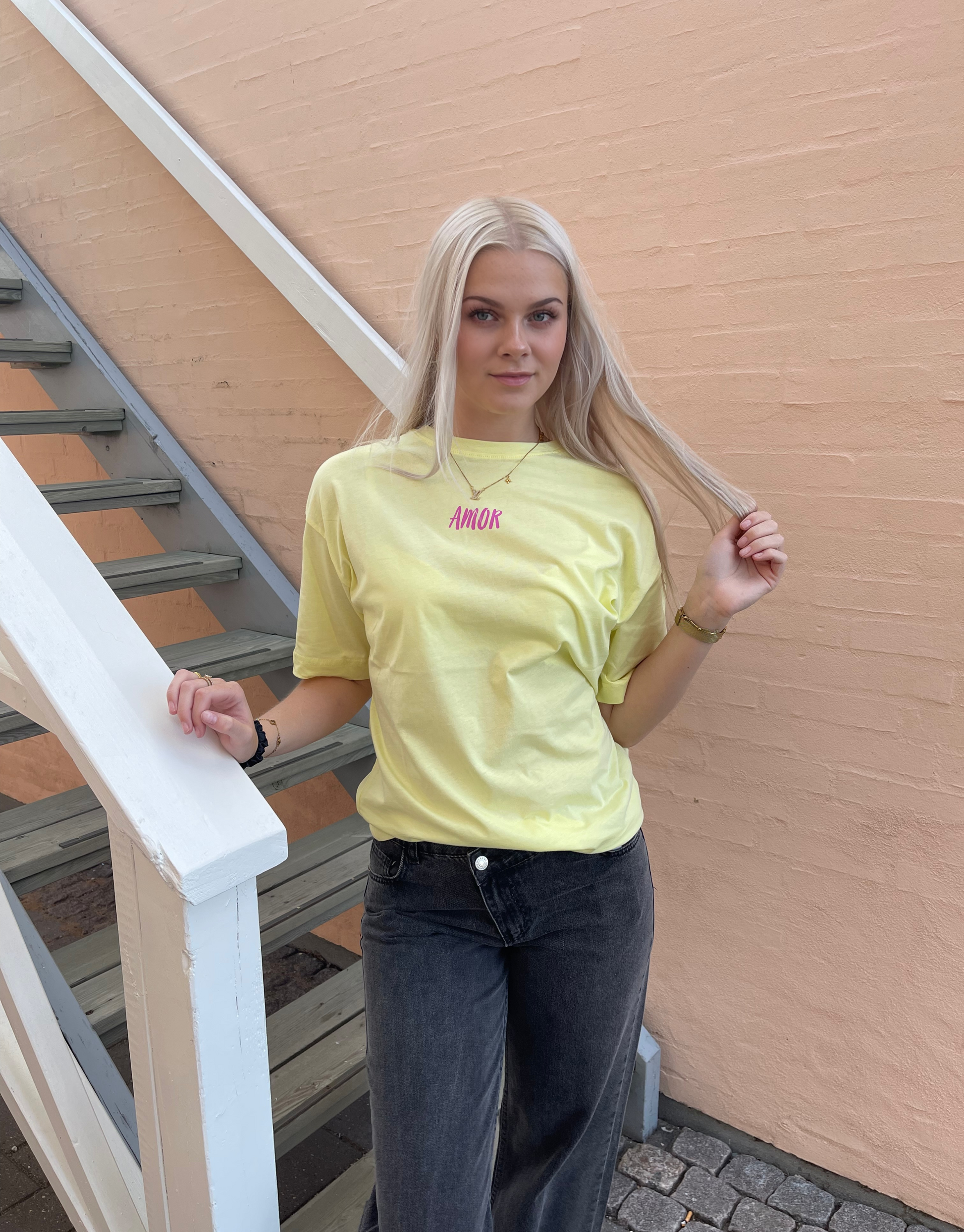 Skøn oversized t-shirt i gul med Amor skrift foran og bagpå samt med en masse detaljer. 