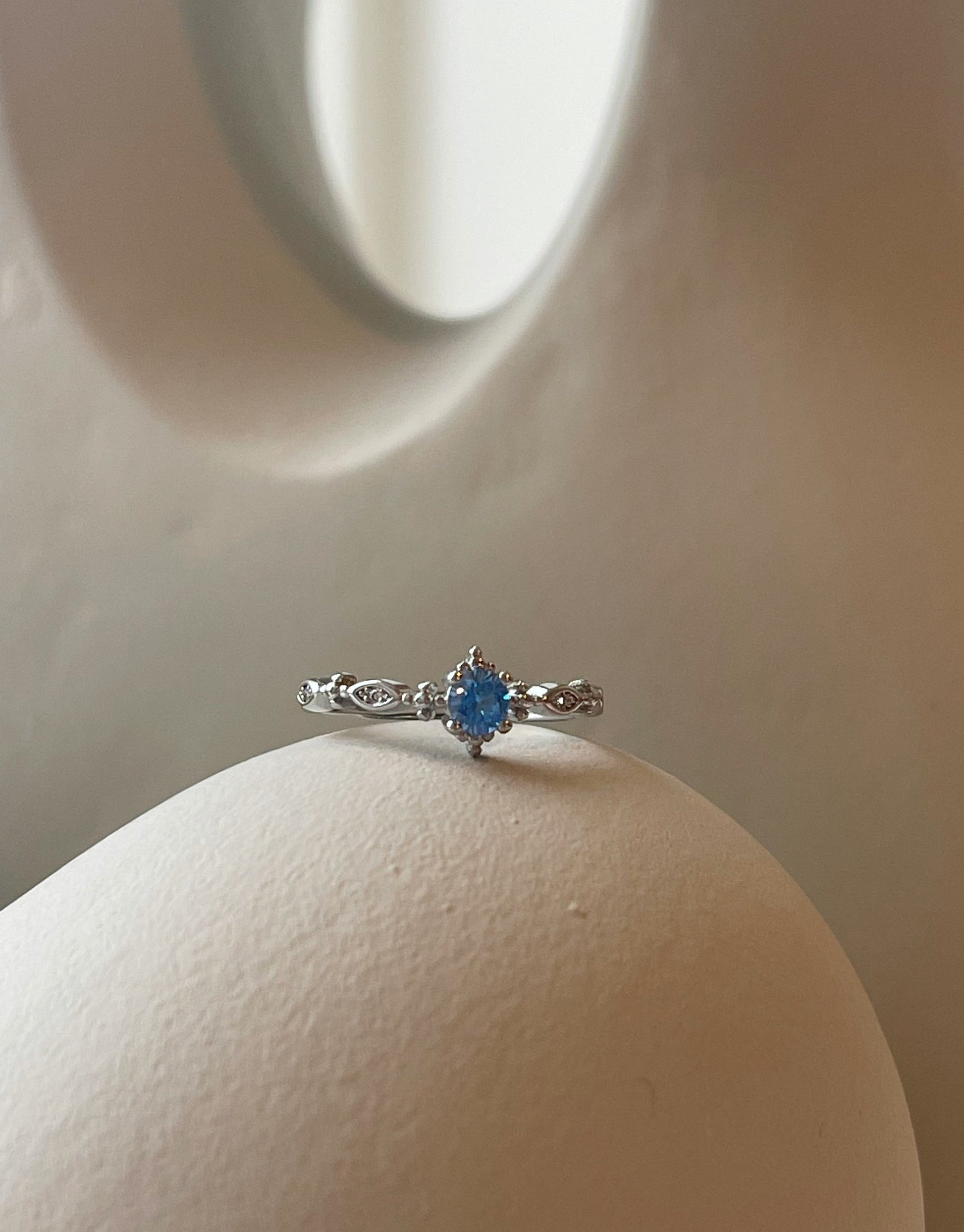 Malua ring i S925 sterling sølv.  Unik ring i elegant design med flot lyseblå zircon sten.  Materiale: S925 sterling sølv, zircon sten Størrelse: Justerbar
